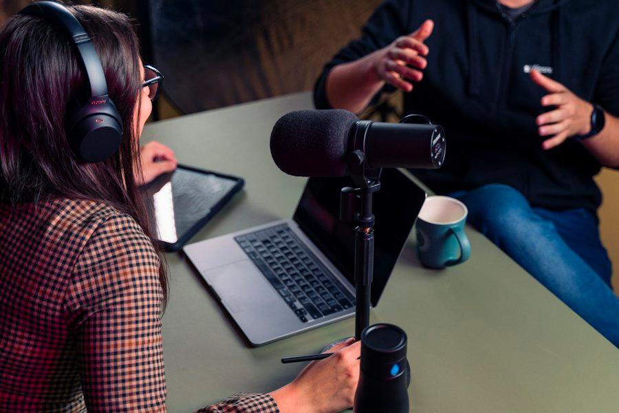 A person wearing headphones working at a laptop