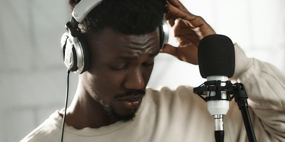 Creator recording with headphones and a microphone
